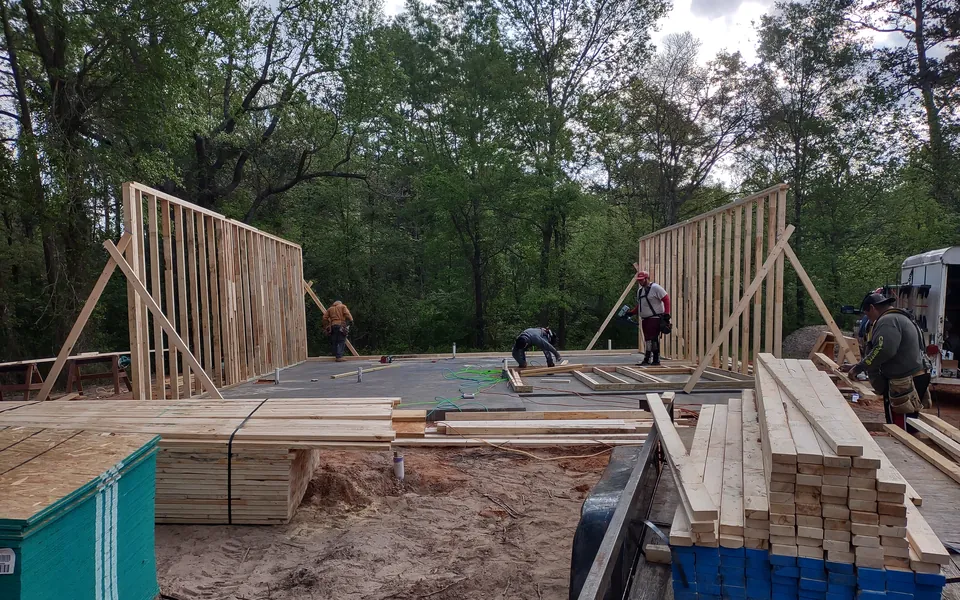 Framed walls going up on a new home slab in East Texas