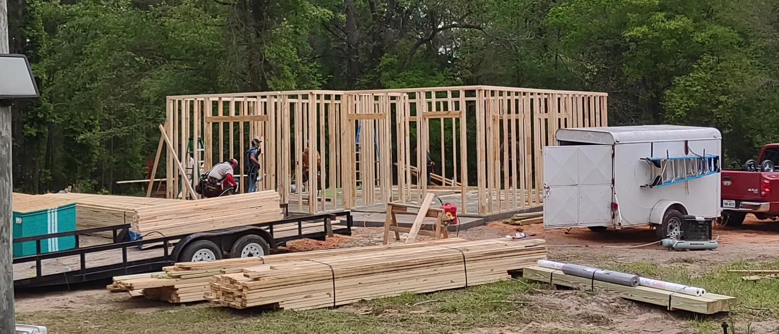 The SMG United Contractors crew framing a new house with lumber staged on site